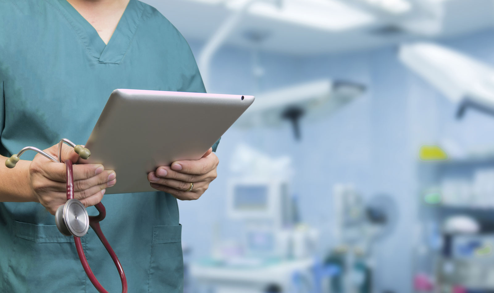 doctor holding ipad and stethoscope